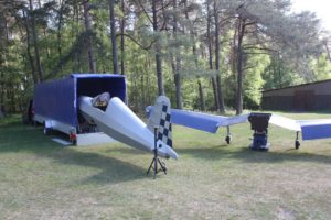 Photo of the Corsair ultralight aircraft being derigged for trailering.